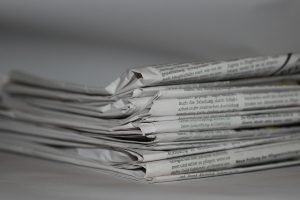 Stack of newspapers - media release