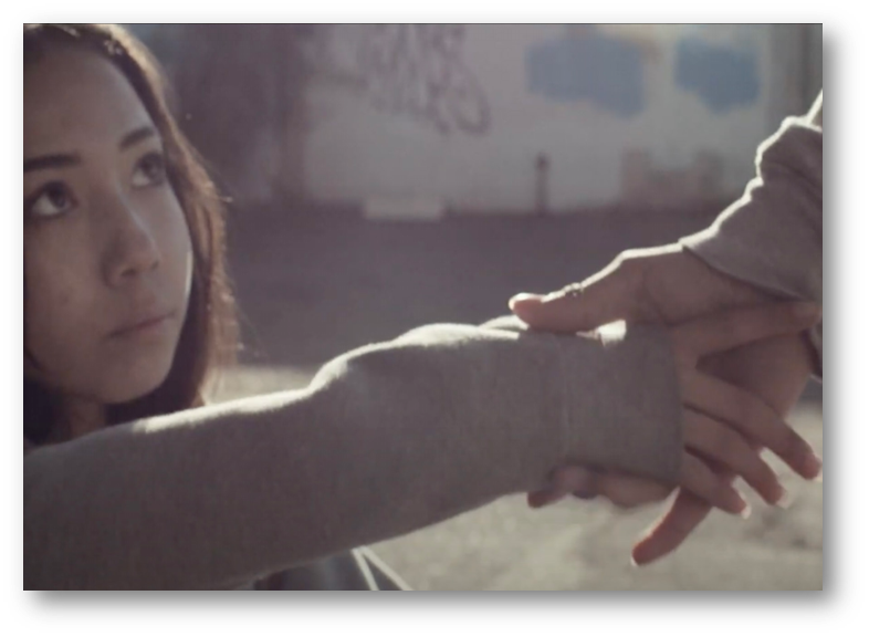 Young girl grabbing the hand of someone